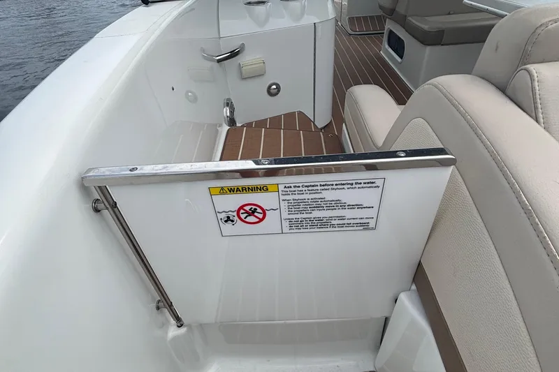 Slide: The Image of 2013 Formula 350 CBR boat interior with safety warning sign and beige seating. - 54