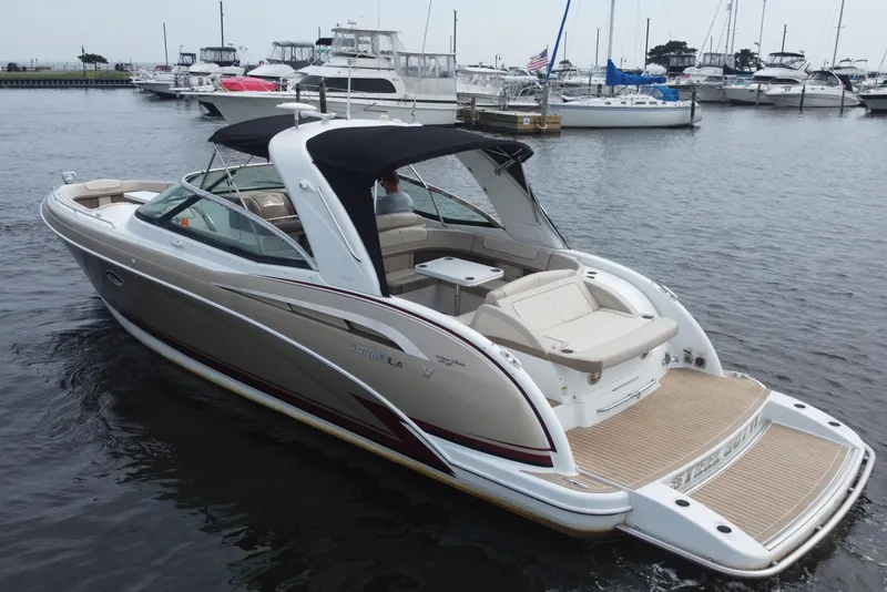 Slide: The Image of 2013 Formula 350 CBR boat docked in a marina, featuring sleek design and spacious seating. - 6