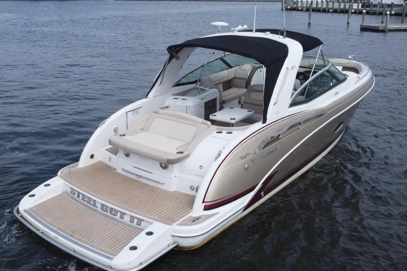 Slide: The Image of 2013 Formula 350 CBR boat with sleek design, beige seating, and black canopy on water. - 7