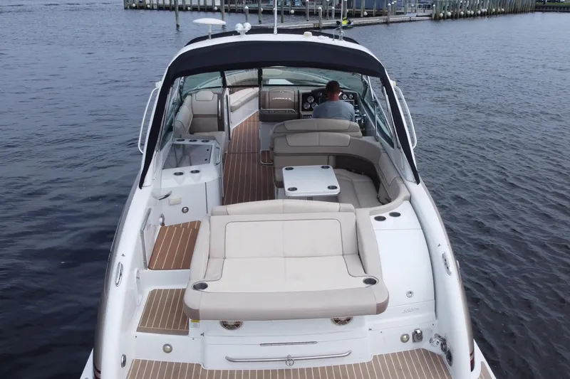 Slide: The Image of 2013 Formula 350 CBR boat with spacious seating on calm water. - 9