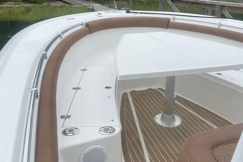 Slide: The Image of 2016 Buddy Davis 28 Center Console boat interior with seating and table. - 14