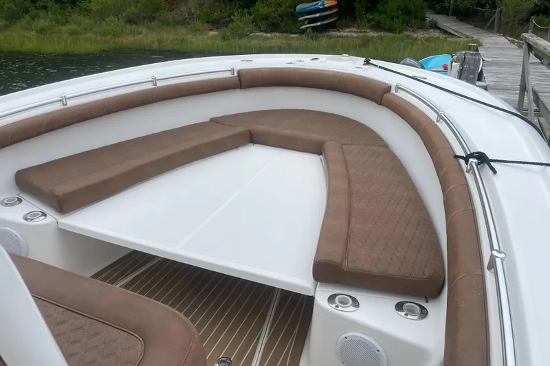 Slide: The Image of 2016 Buddy Davis 28 Center Console boat with brown cushioned seating and white deck. - 17