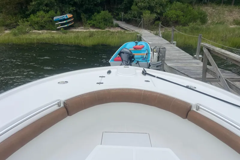 Slide: The Image of 2016 Buddy Davis 28 Center Console docked near wooden pier with kayaks. - 19