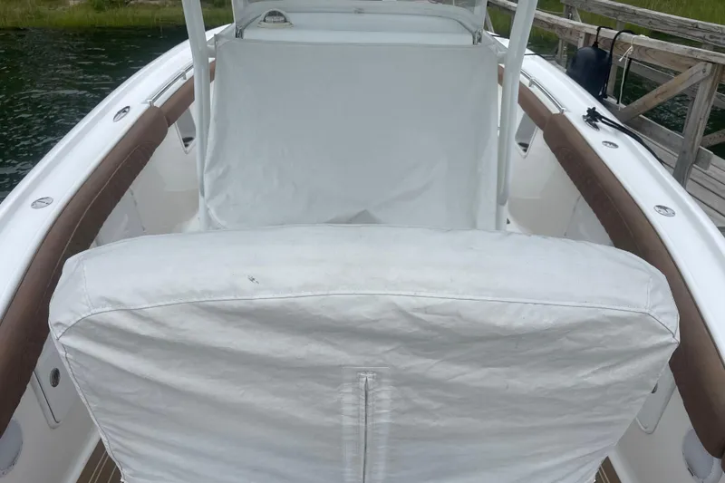 Slide: The Image of 2016 Buddy Davis 28 Center Console boat interior with white seating and brown trim. - 27
