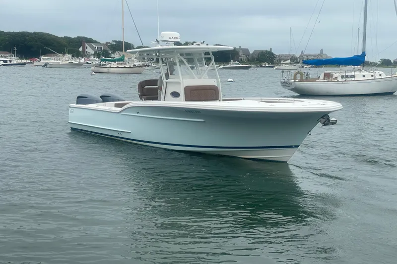Slide: The Image of 2016 Buddy Davis 28 Center Console boat on calm water, surrounded by other vessels. - 29