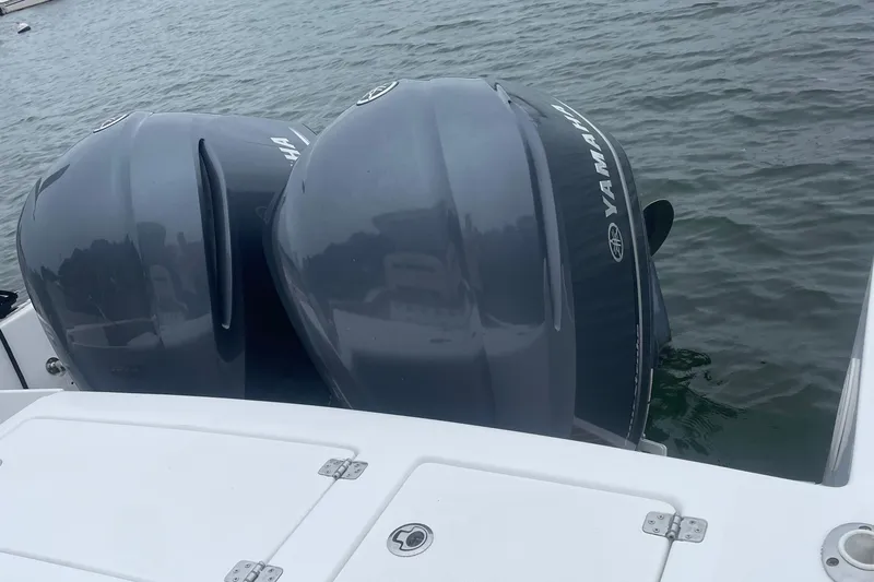 Slide: The Image of 2016 Buddy Davis 28 Center Console with twin Yamaha outboard motors on water. - 4