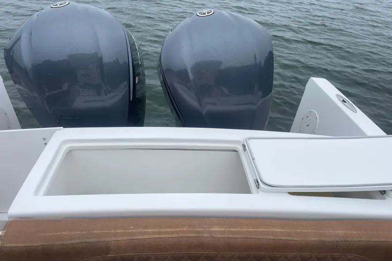Slide: The Image of 2016 Buddy Davis 28 Center Console with dual outboard motors on water. - 6