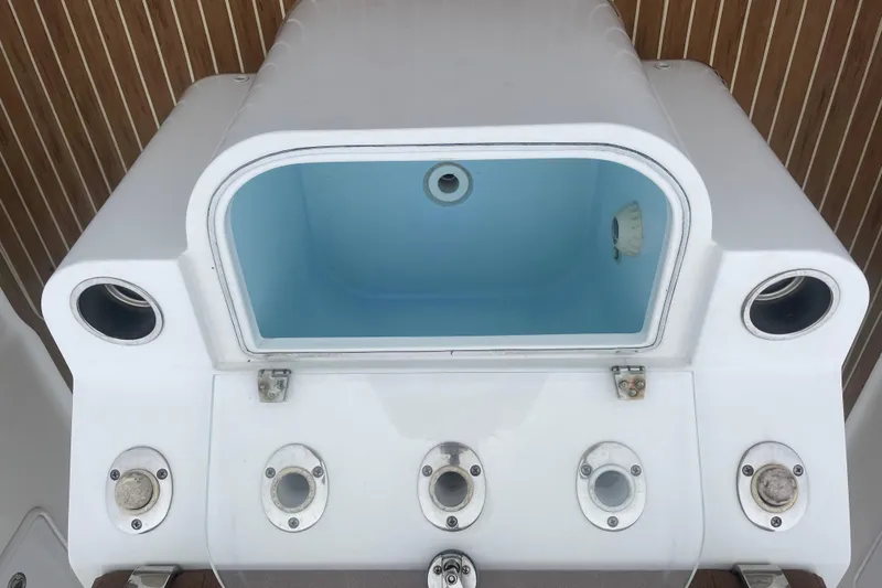 Slide: The Image of 2016 Buddy Davis 28 Center Console boat livewell and rod holders. - 7