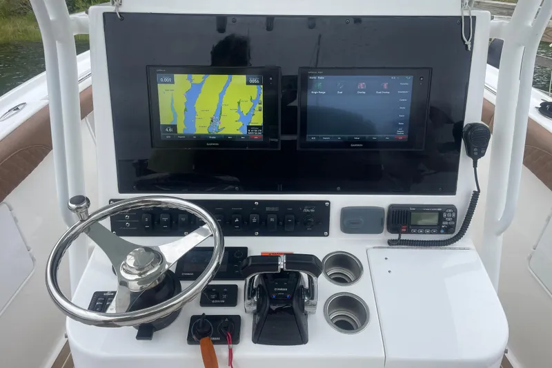 Slide: The Image of 2016 Buddy Davis 28 Center Console helm with dual Garmin displays and steering wheel. - 8