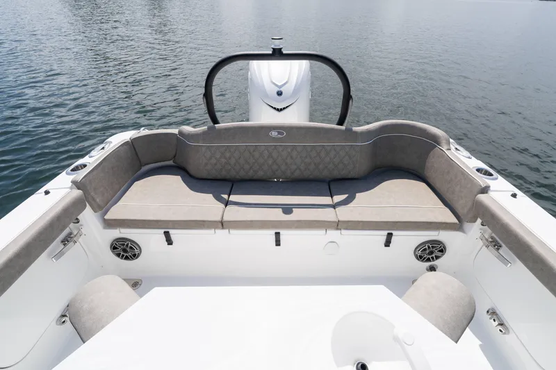 Slide: The Image of 2026 Sea Hunt Ultra 255 SE boat interior with cushioned seating and water view. - 2