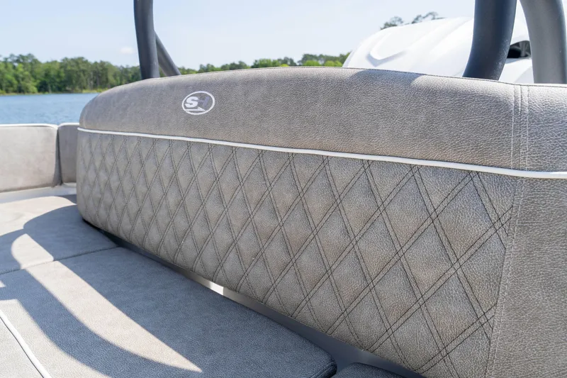Slide: The Image of 2026 Sea Hunt Ultra 255 SE boat seat with diamond stitching, lake view background. - 8