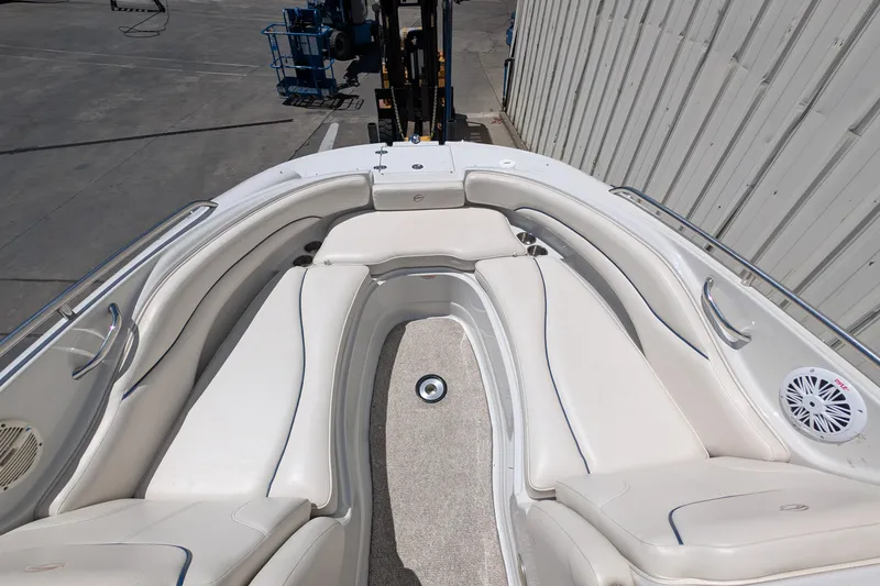 Slide: The Image of 2006 Crownline 240 EX boat interior with white seating and speaker. - 10