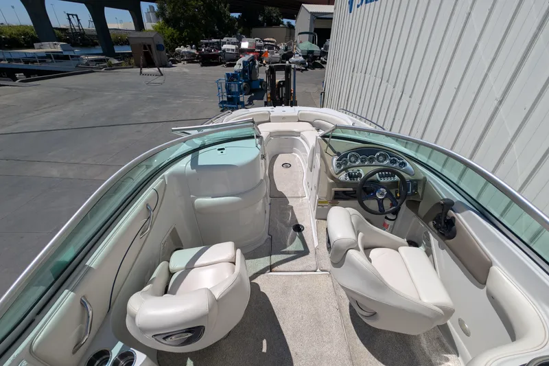 Slide: The Image of 2006 Crownline 240 EX boat interior with steering wheel and seating. - 11