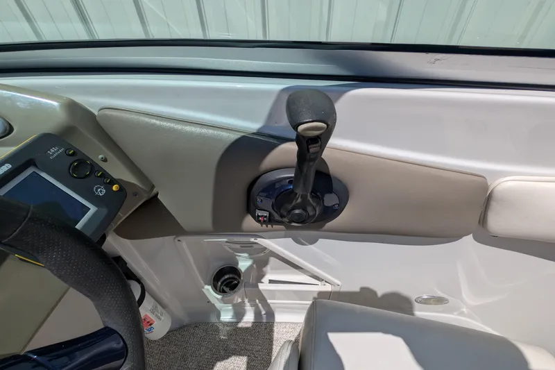 Slide: The Image of 2006 Crownline 240 EX boat cockpit with throttle control and navigation display. - 13