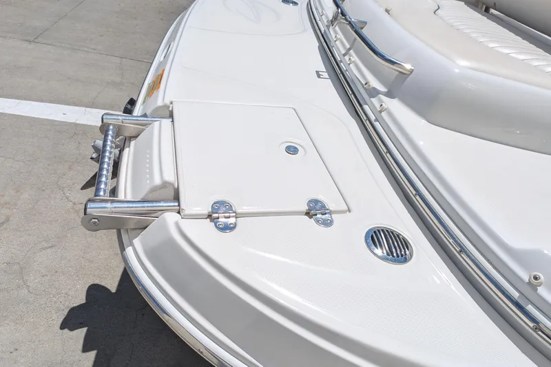 Slide: The Image of 2006 Crownline 240 EX boat deck with stainless steel fittings and seating. - 17