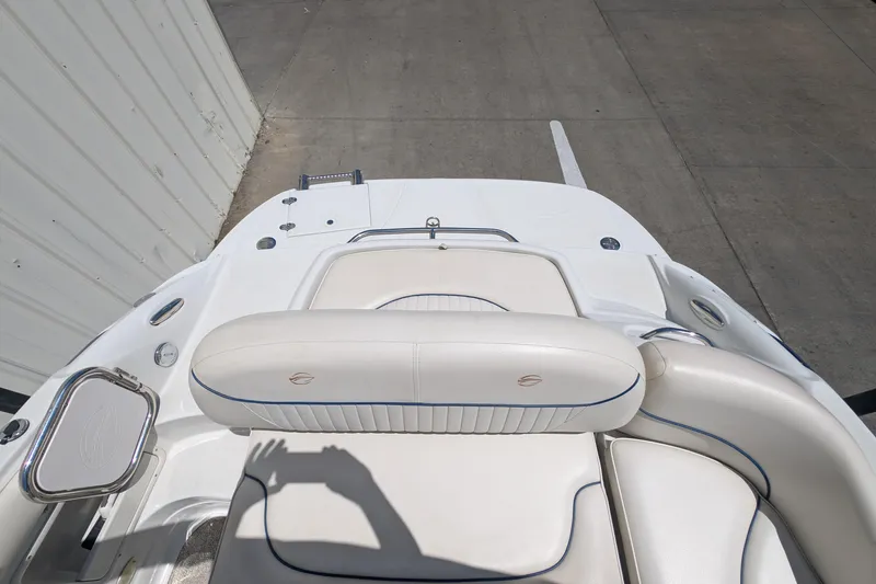 Slide: The Image of 2006 Crownline 240 EX boat interior with white seating and blue accents. - 18