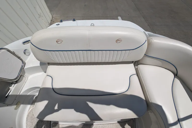 Slide: The Image of 2006 Crownline 240 EX boat interior with white cushioned seating and blue trim. - 19