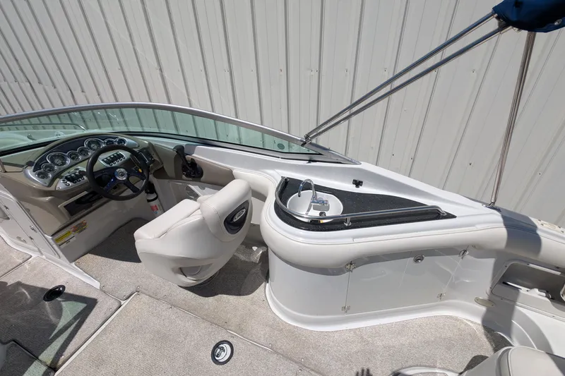Slide: The Image of Interior of a 2006 Crownline 240 EX boat with steering wheel and sink. - 23