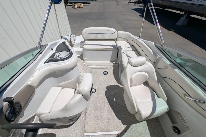 Slide: The Image of 2006 Crownline 240 EX boat interior with white seating and steering wheel. - 8