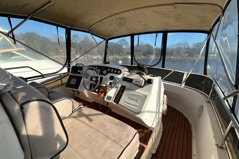 Slide: The Image of 1999 Silverton 442 Cockpit Motor Yacht interior with helm, navigation equipment, and seating. - 16