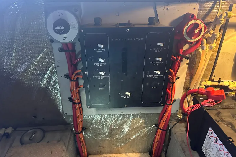 Slide: The Image of Electrical panel of a 1999 Silverton 442 Cockpit Motor Yacht with wiring and switches. - 2