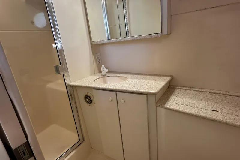 Slide: The Image of Bathroom interior of 1999 Silverton 442 Cockpit Motor Yacht with shower and vanity. - 23