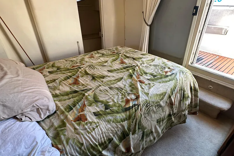 Slide: The Image of Cozy bedroom in 1999 Silverton 442 Cockpit Motor Yacht with tropical bedding. - 25