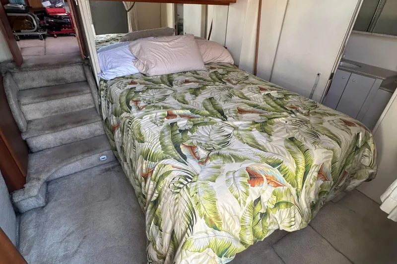 Slide: The Image of Cozy bedroom in 1999 Silverton 442 Cockpit Motor Yacht with tropical bedding. - 26