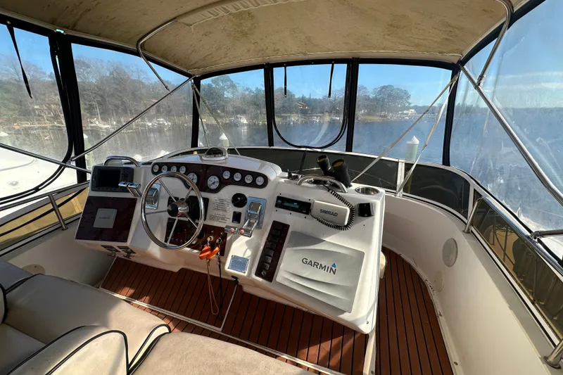 Slide: The Image of 1999 Silverton 442 Cockpit Motor Yacht helm with Garmin navigation system. - 28