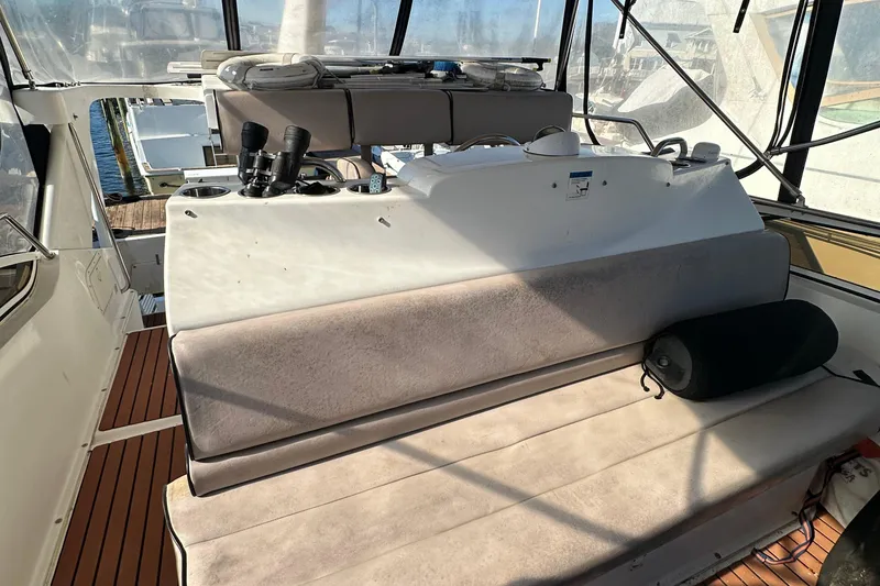Slide: The Image of 1999 Silverton 442 Cockpit Motor Yacht interior with seating and navigation equipment. - 29