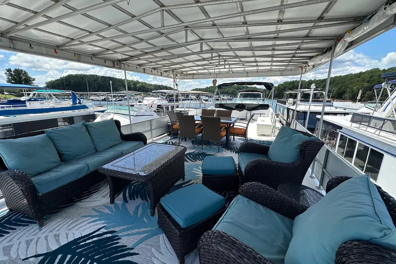 Slide: The Image of Spacious deck of 1990 Sumerset 14x65 houseboat with comfortable seating and scenic marina view. - 12