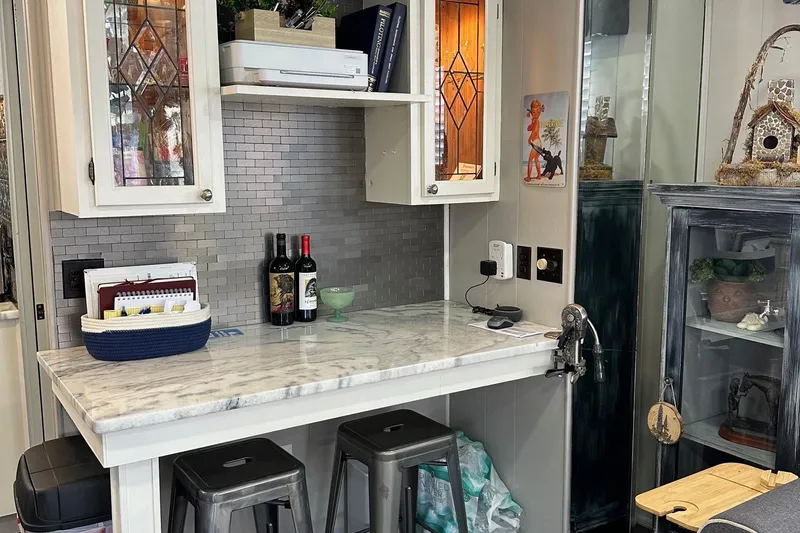 Slide: The Image of Cozy kitchen nook in a 1990 Sumerset 14x65 houseboat with marble countertop and decorative cabinets. - 5