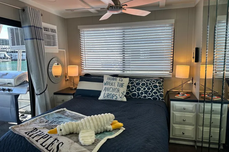 Slide: The Image of Cozy bedroom in 1990 Sumerset 14x65 houseboat with nautical decor and marina view. - 8