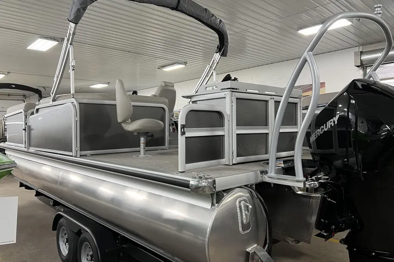 Slide: The Image of 2023 Premier Sunsation Angler 230 pontoon boat in a showroom, featuring Mercury outboard motor. - 3
