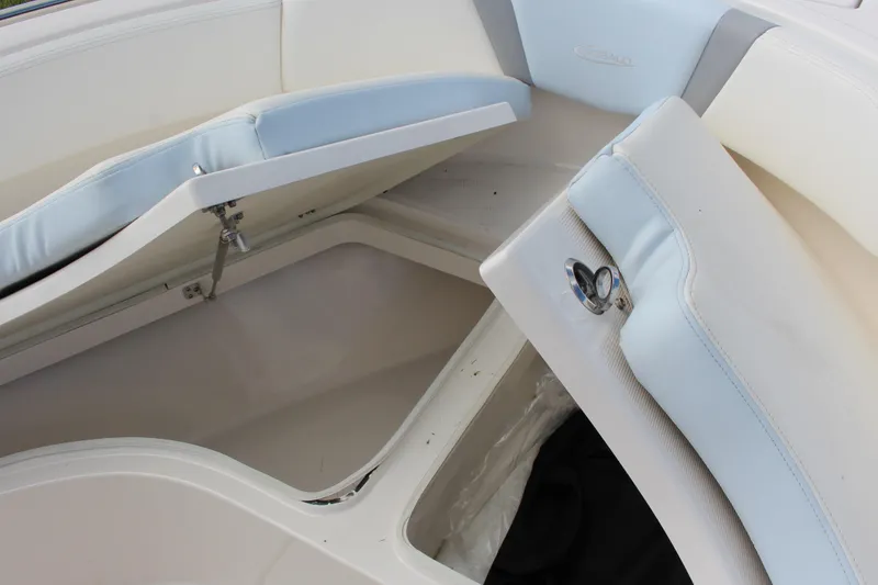 Slide: The Image of 2023 Robalo R222 Center Console boat storage compartment with open cushioned seats. - 10