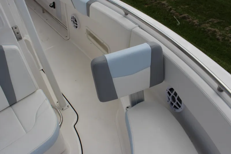 Slide: The Image of 2023 Robalo R222 Center Console boat interior with cushioned seating and speaker. - 12