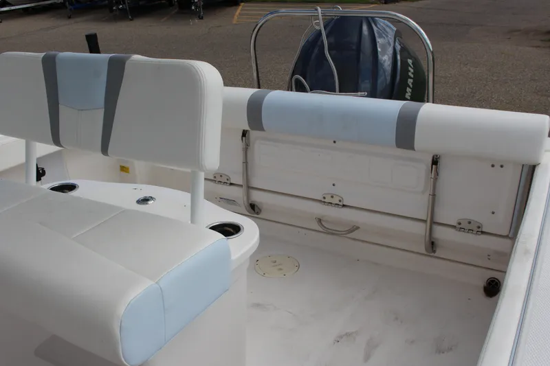 Slide: The Image of 2023 Robalo R222 Center Console boat interior with cushioned seating and Yamaha engine. - 15