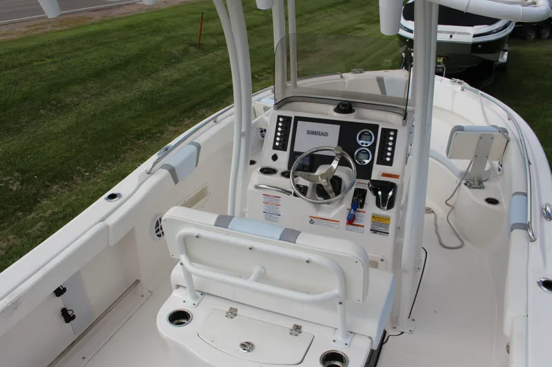 Slide: The Image of 2023 Robalo R222 Center Console boat interior with steering wheel and controls. - 17