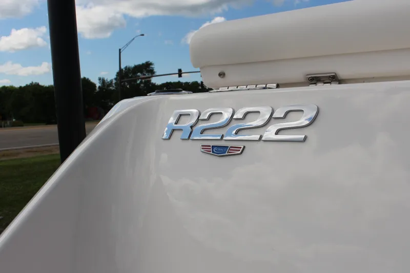 Slide: The Image of 2023 Robalo R222 Center Console boat emblem under a cloudy sky. - 18