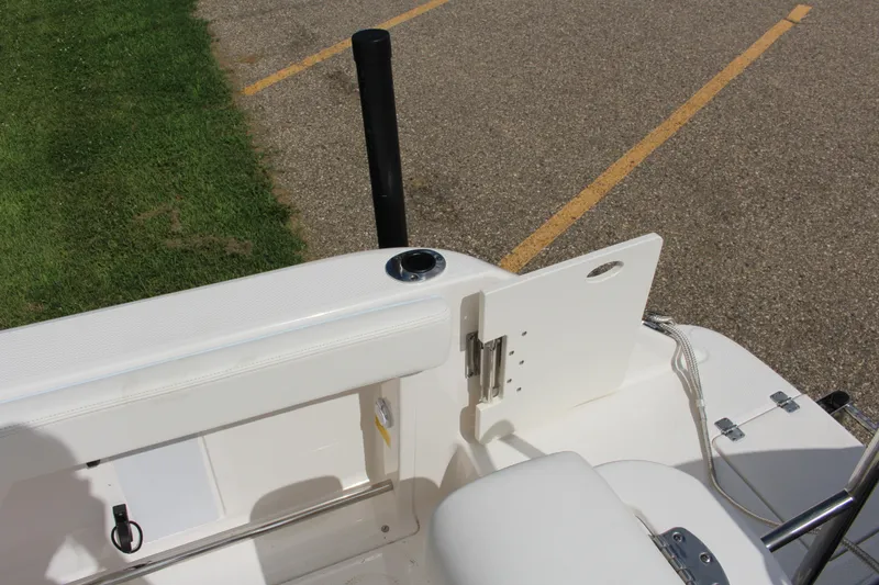 Slide: The Image of 2023 Robalo R222 Center Console boat interior with white seating and storage compartment. - 32