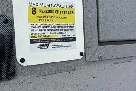 Slide: The Image of Capacity label on 2026 SeaArk ProCat 240 boat, maximum 8 persons or 1110 lbs. - 6