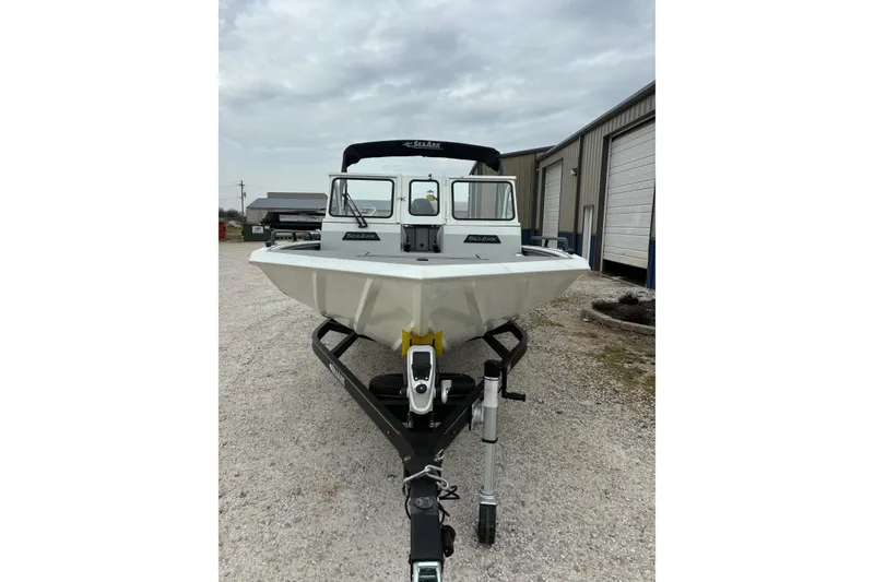 Slide: The Image of 2026 SeaArk ProCat 240 boat on trailer, parked outdoors near industrial buildings. - 8