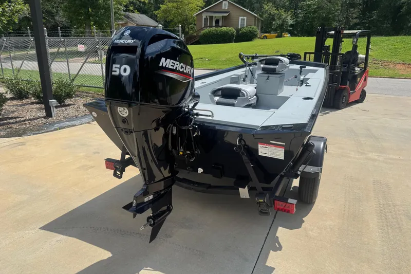 Slide: The Image of 2025 Crestliner 1657 Outlook Stick Steer boat on trailer, displayed outdoors. - 3