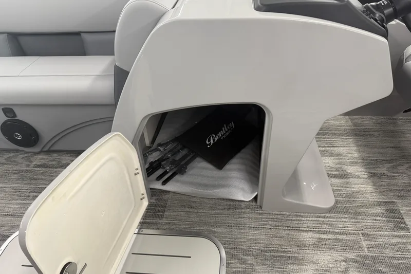 Slide: The Image of 2026 Bentley Pontoons Legacy 243 Navigator interior storage compartment with open door. - 12