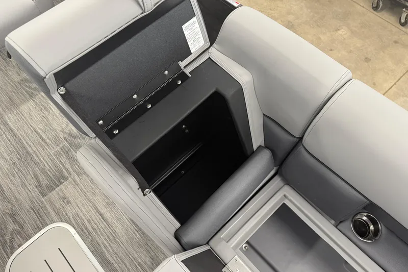 Slide: The Image of 2026 Bentley Pontoons Legacy 243 Navigator interior storage compartment, gray seating, and flooring. - 24