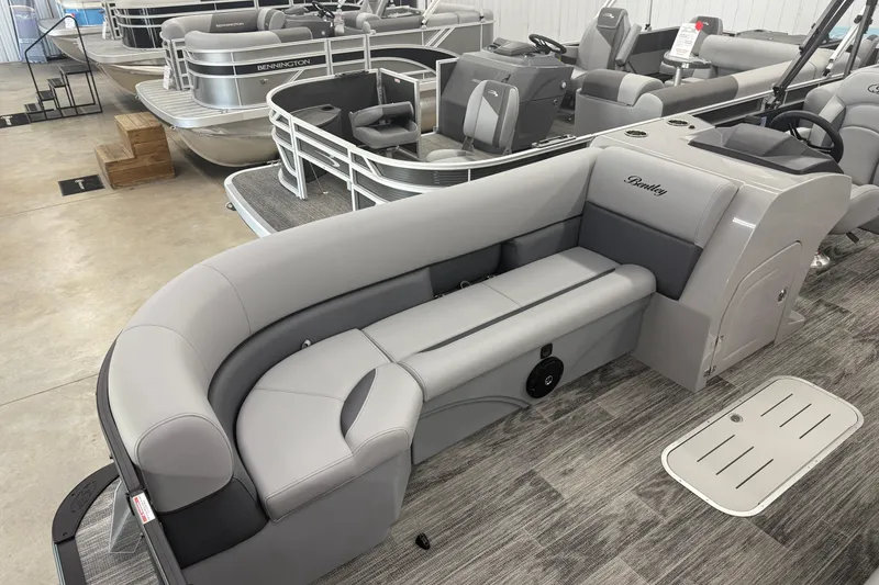 Slide: The Image of 2026 Bentley Pontoons Legacy 243 Navigator with sleek seating in showroom. - 6