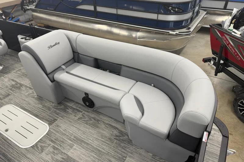 Slide: The Image of 2026 Bentley Pontoons Legacy 243 Navigator with luxurious gray seating in showroom. - 7