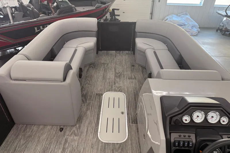 Slide: The Image of 2026 Bentley Pontoons Legacy 243 Navigator interior with gray seating and modern dashboard. - 8