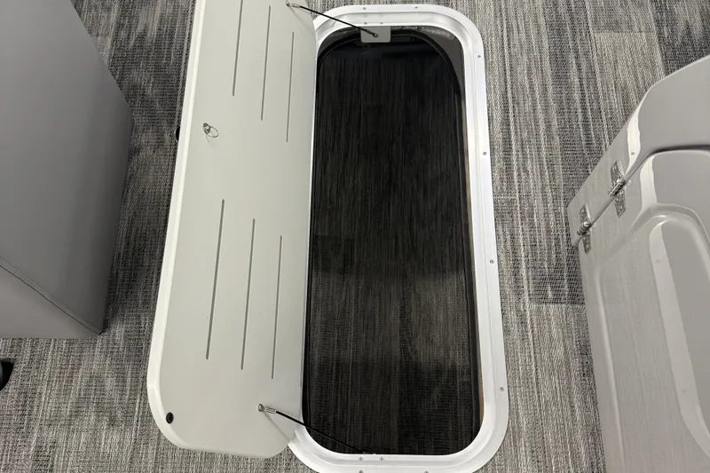 Slide: The Image of Open storage compartment on 2026 Bentley Pontoons Legacy 243 Navigator boat. - 9