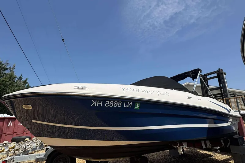Slide: The Image of 2020 Bayliner VR4 Bowrider OB boat on trailer under clear blue sky. - 1
